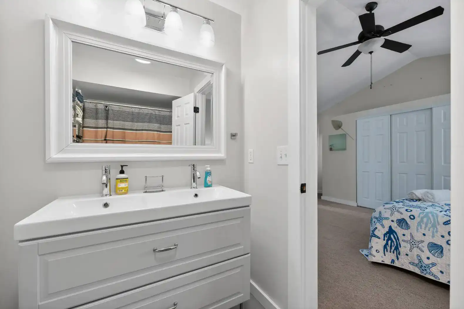 Bright bathroom with modern vanity and large mirror