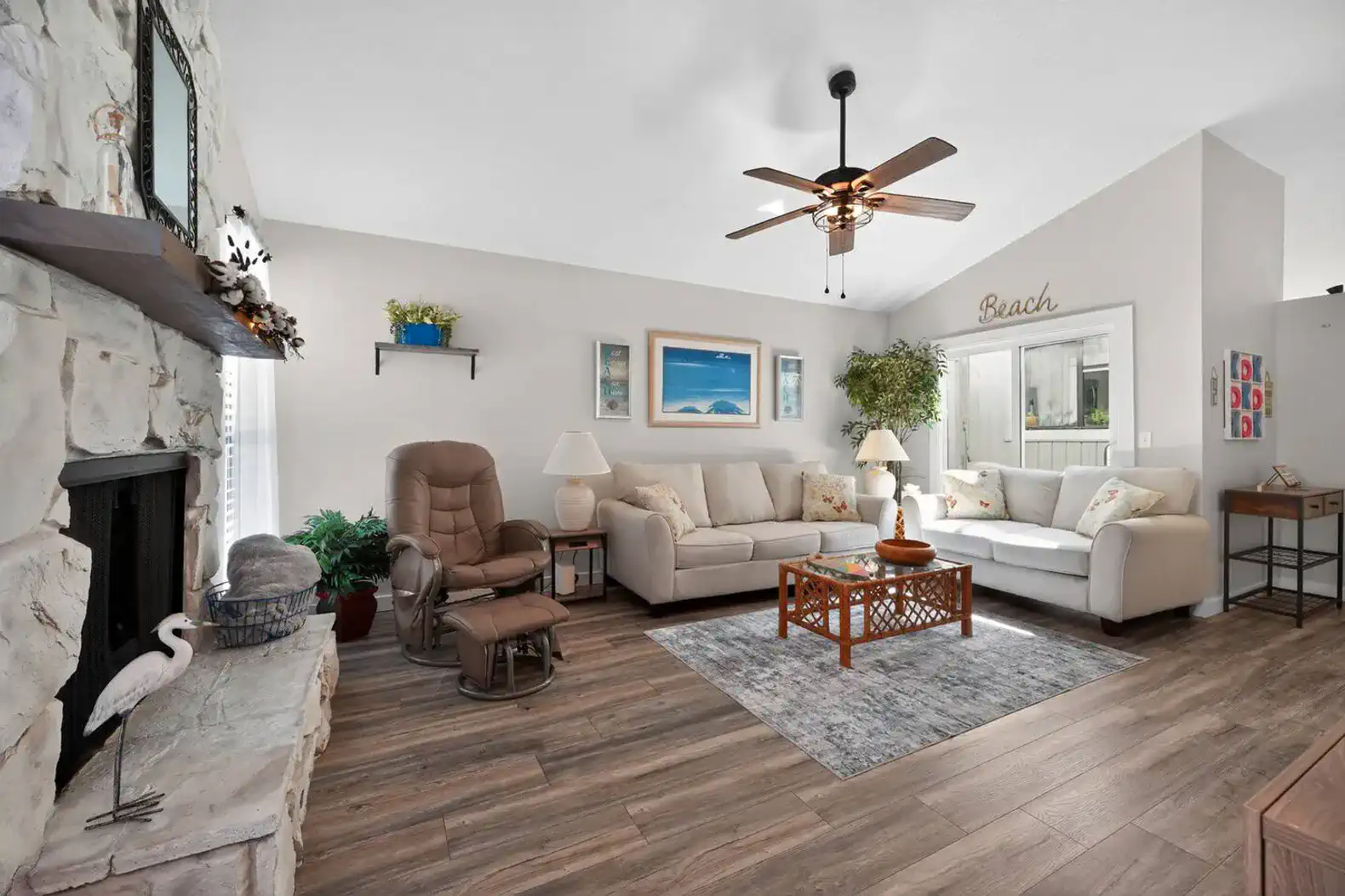 Cozy living room with comfortable seating and decorative beach-themed accents