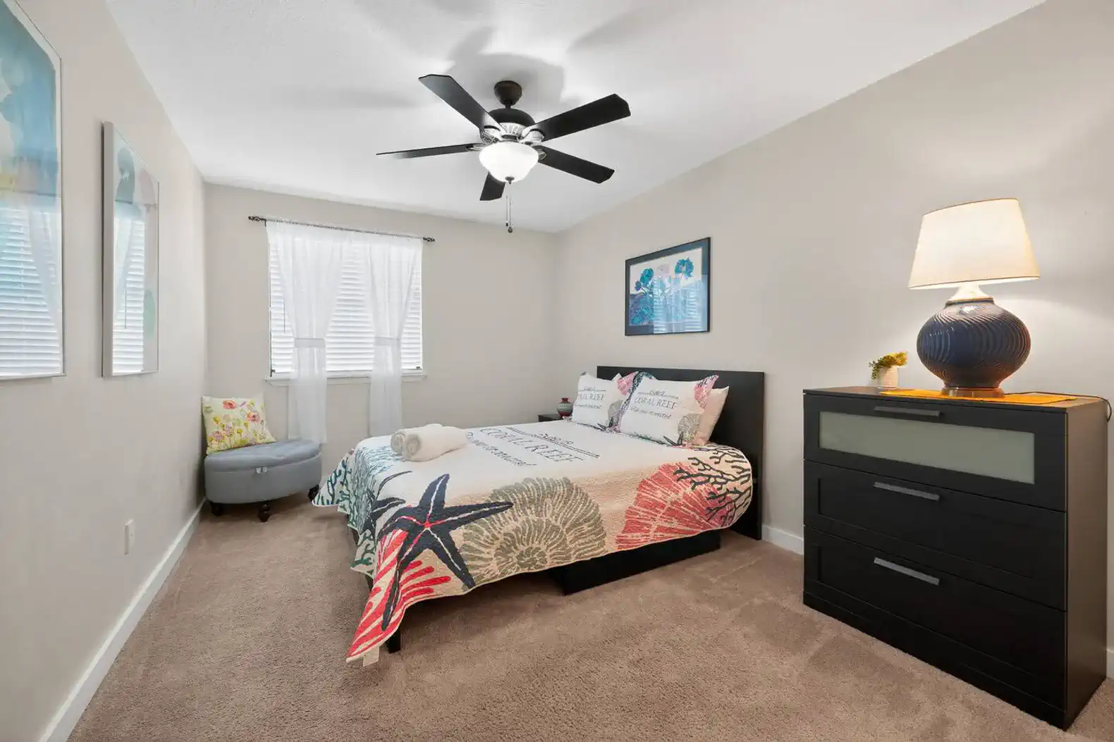 Cozy guest bedroom with a colorful quilt and modern furnishings