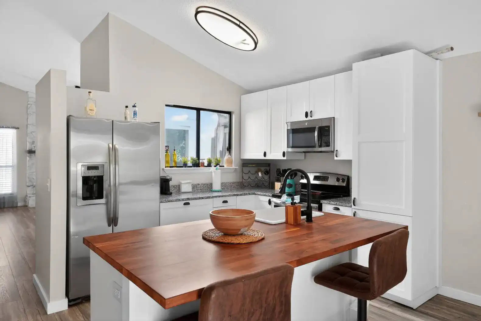 Modern kitchen with stainless steel appliances and a wooden dining table