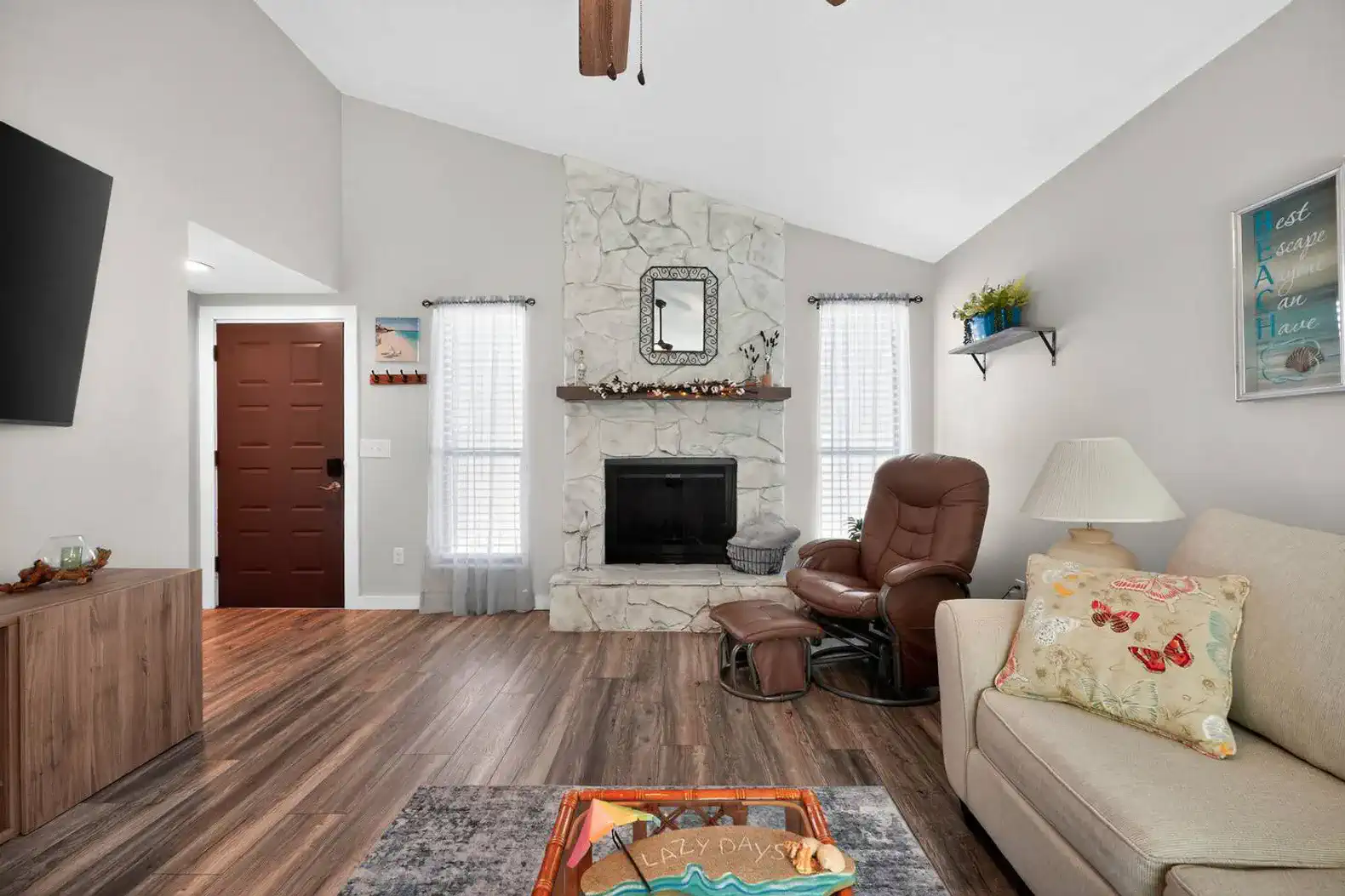 Cozy living room with stone fireplace and comfortable seating