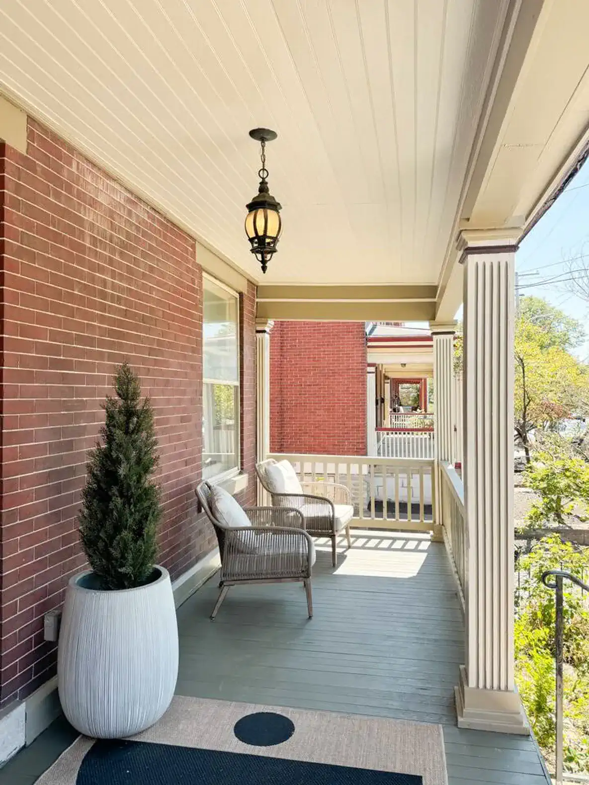 Charming porch with seating and decorative plant