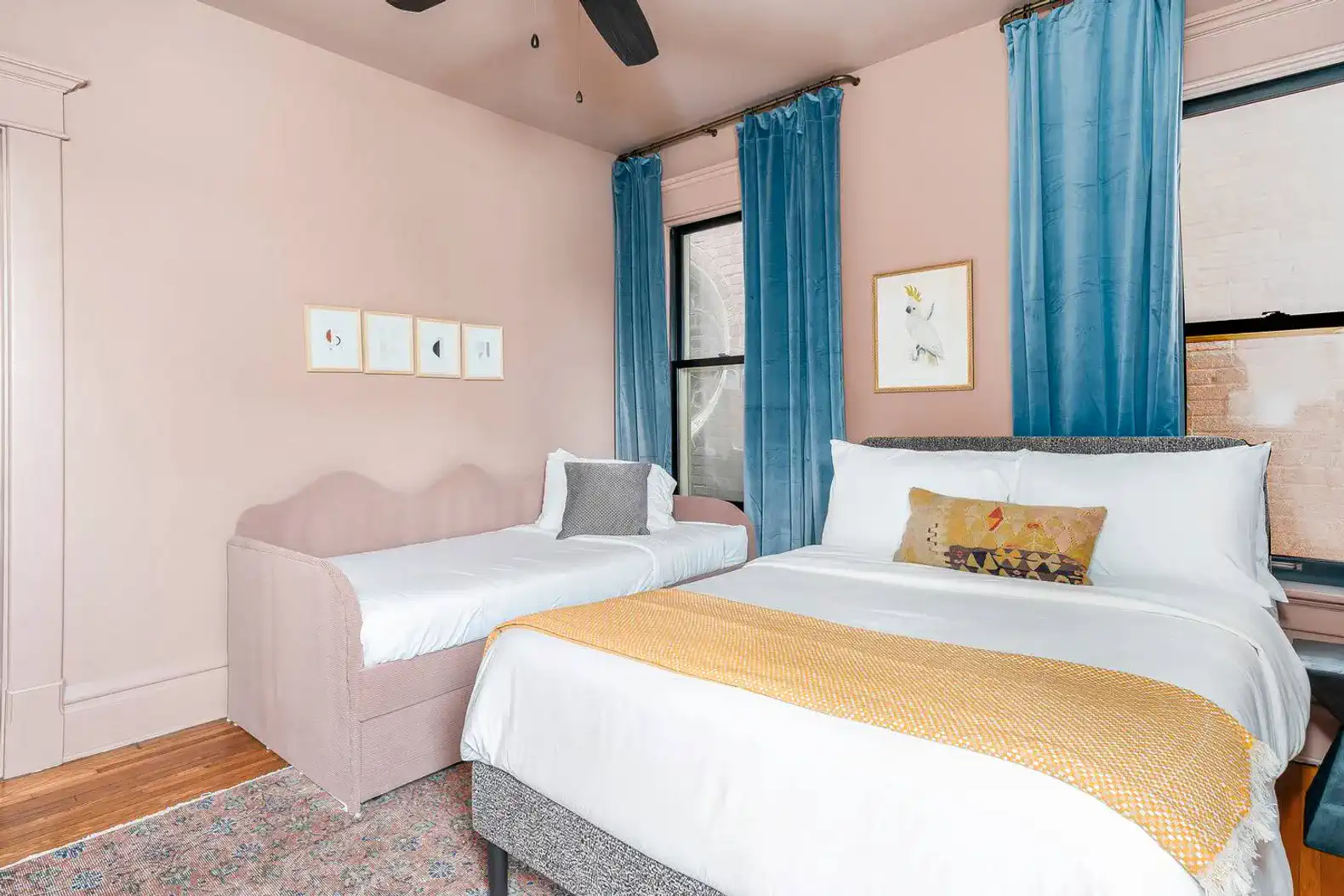The pink room offers both a full bed and a twin bed.
