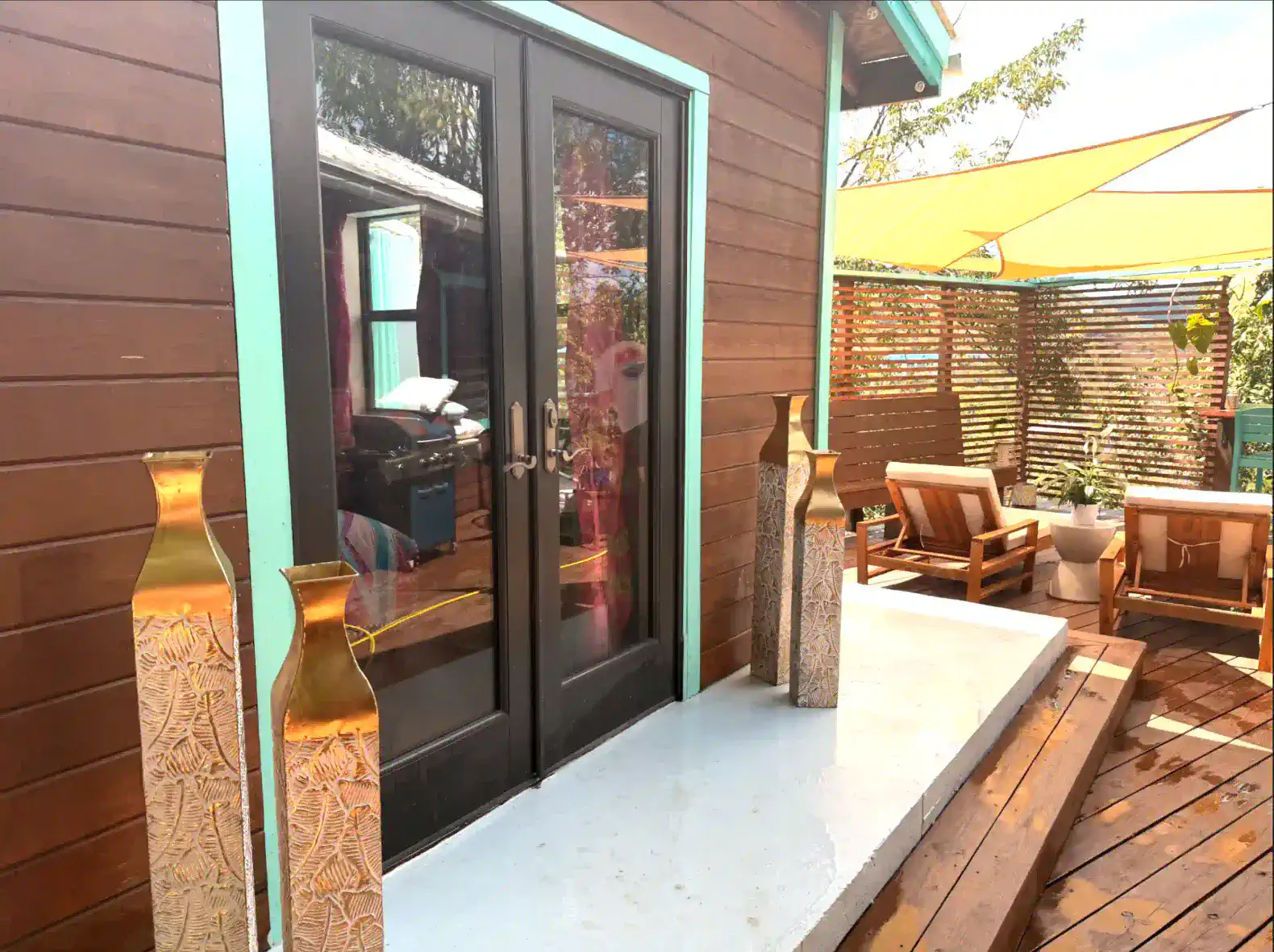 Stylish entrance with decorative vases and outdoor seating area