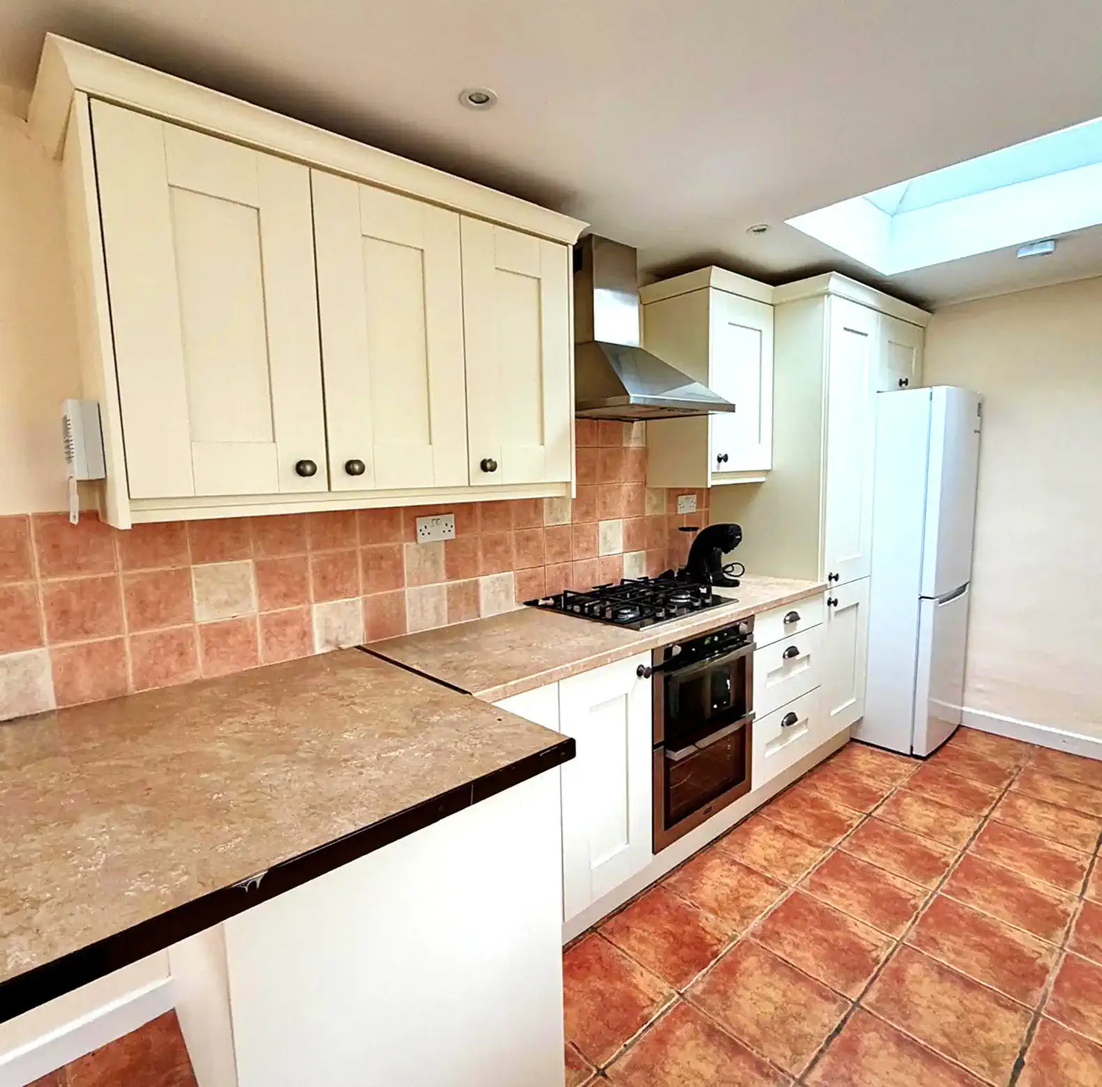 Bright kitchen with modern appliances and tiled flooring