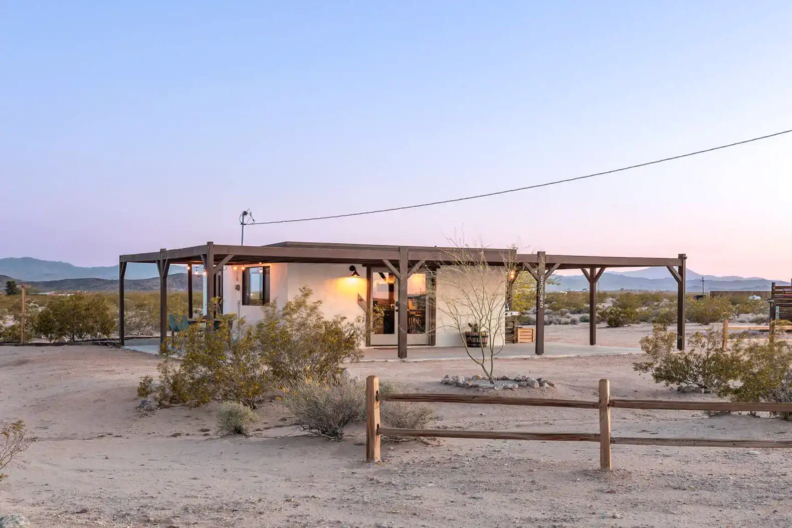 Desert home with a covered porch and surrounding landscape
