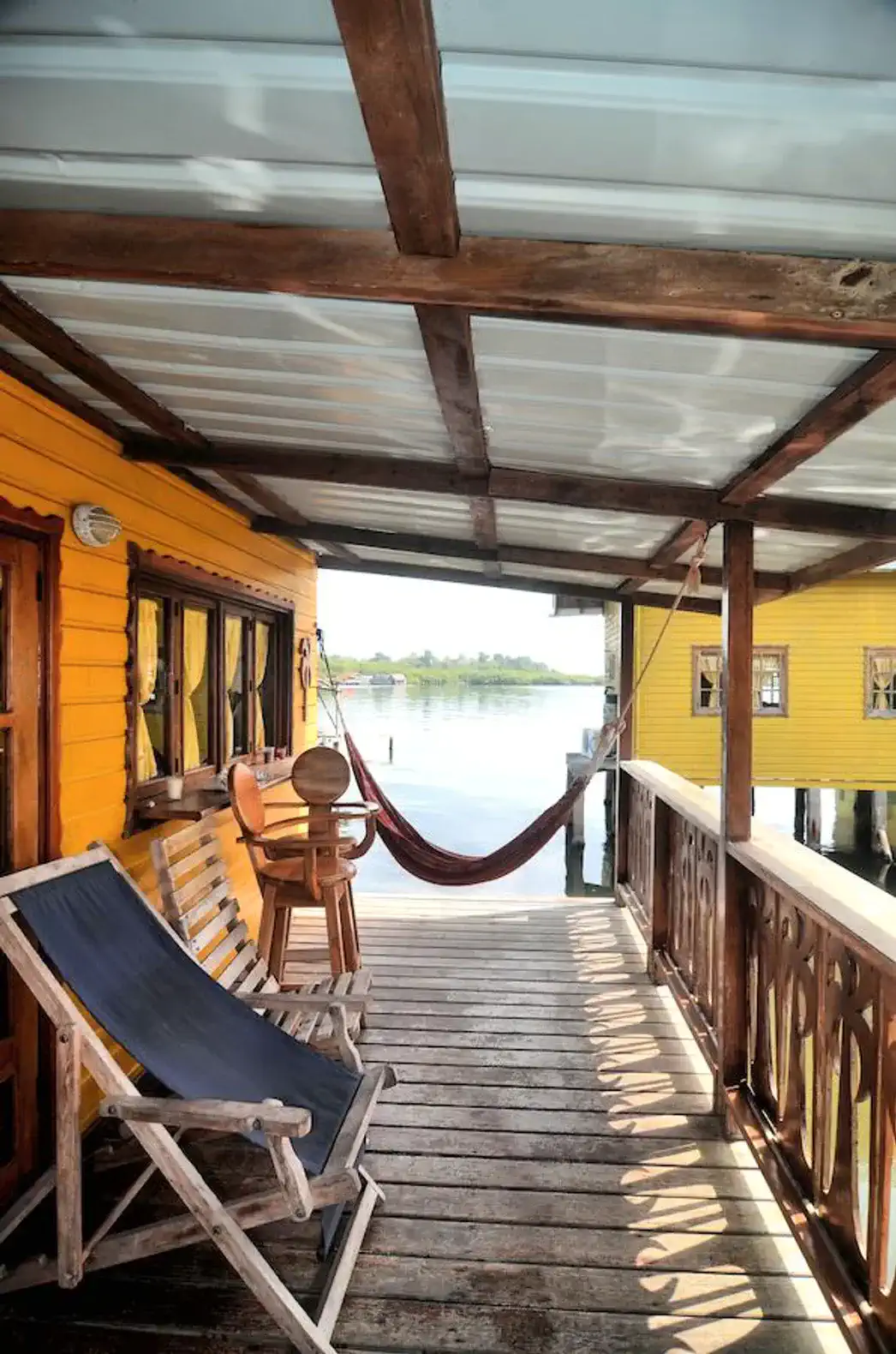 Relaxing outdoor seating area with a hammock and views of the water