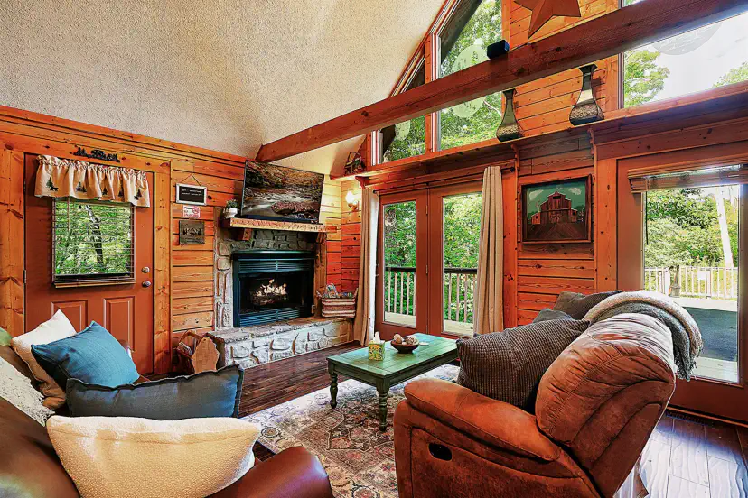 Beams, log walls and a stone fireplace