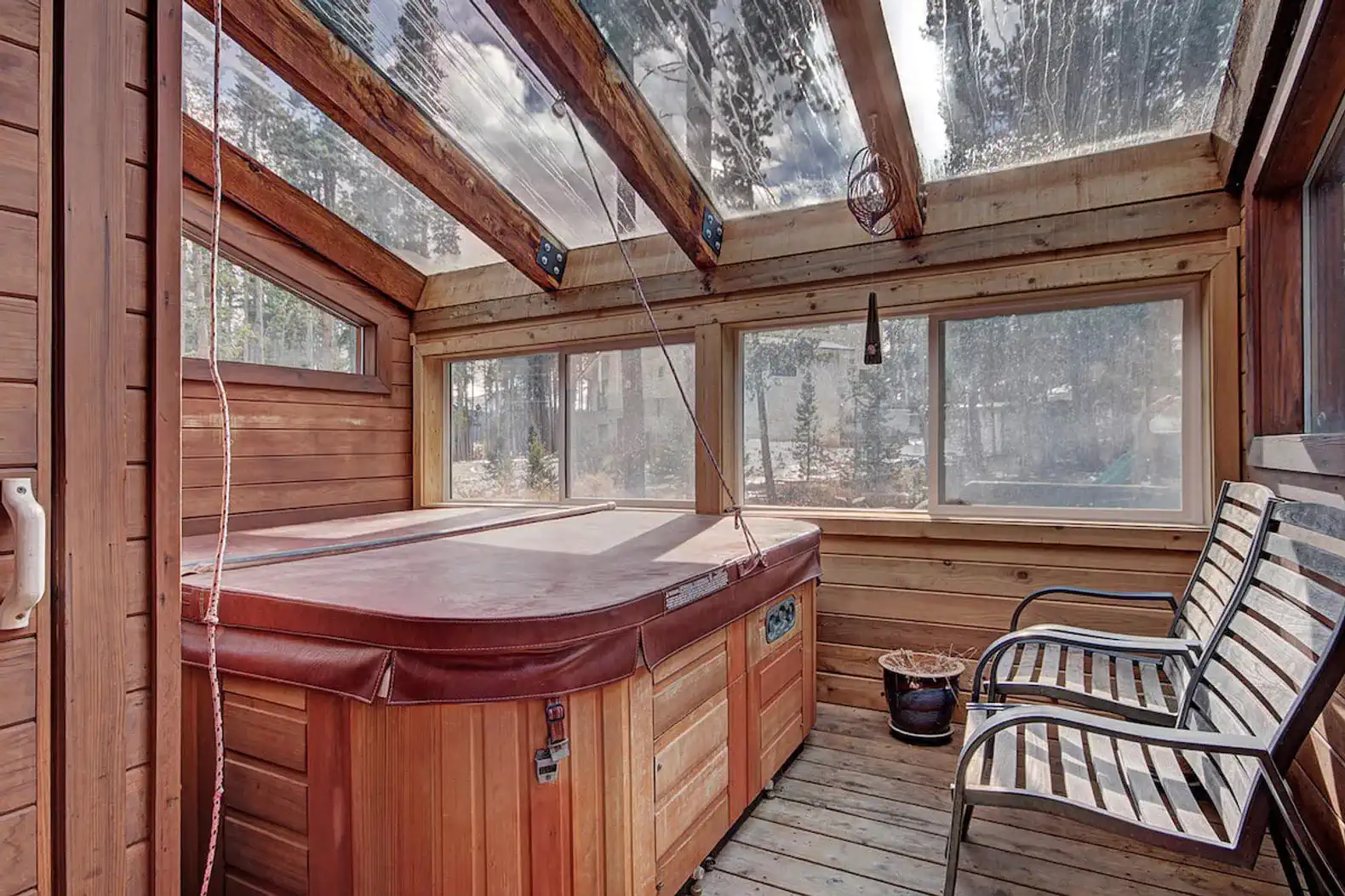 Cozy hot tub area with wooden walls and large windows for natural light