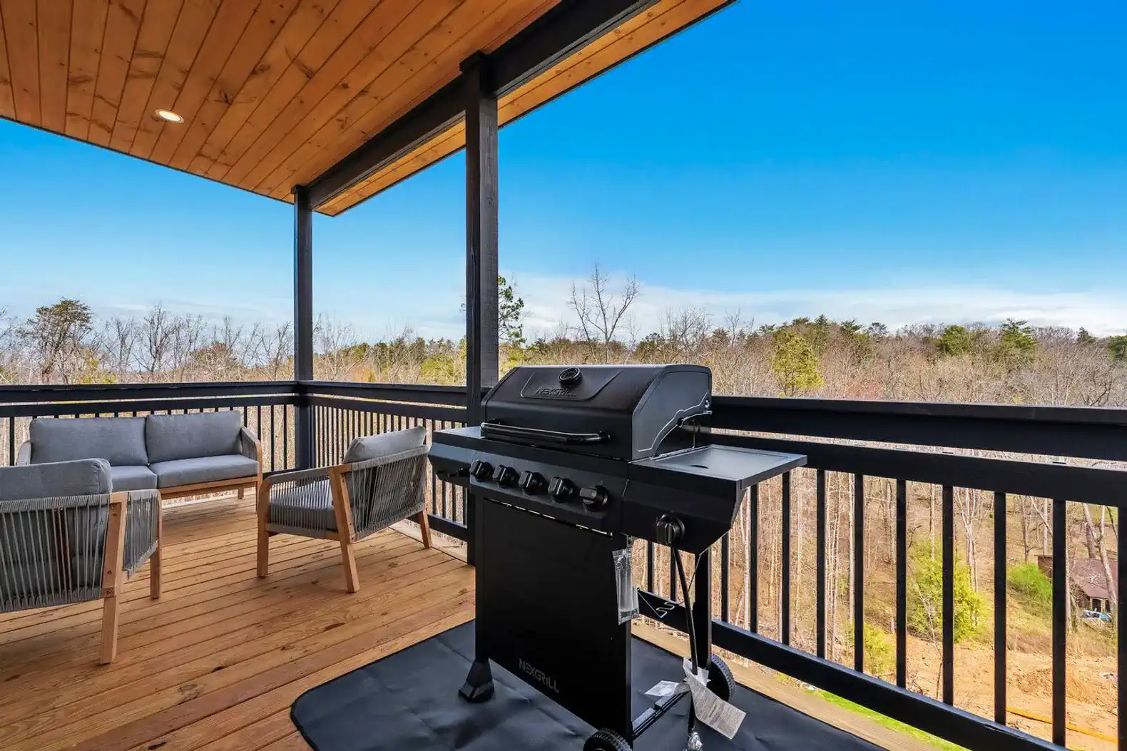 Outdoor seating area with a BBQ grill and scenic views