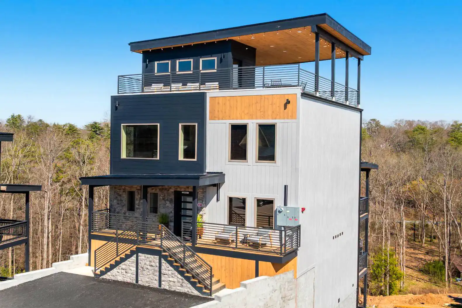Modern multi-level house with rooftop terrace and large windows