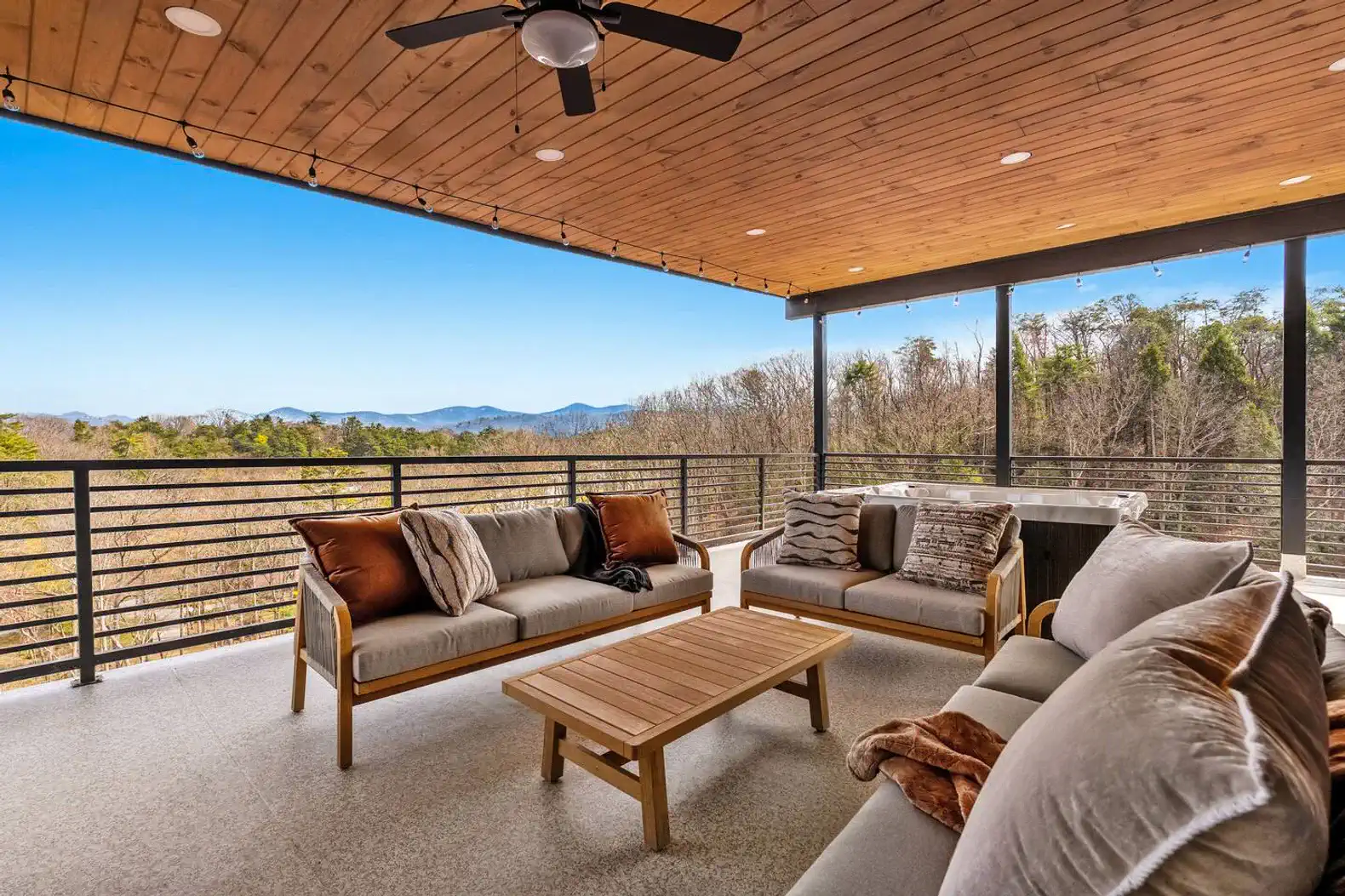 Spacious outdoor seating area with mountain views and cozy furnishings