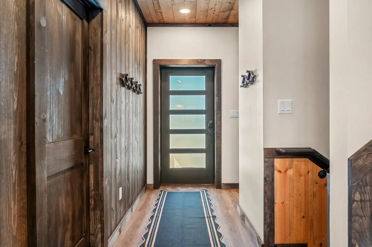 Stylish hallway with wooden accents and modern door