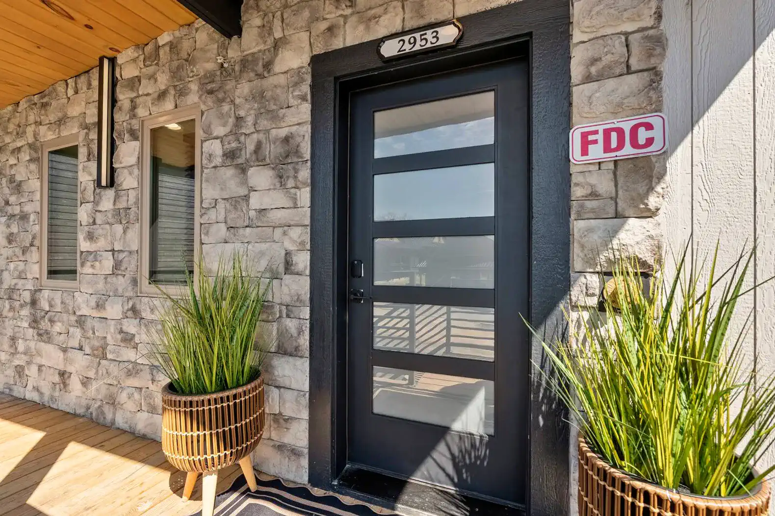 Stylish entrance with modern door and decorative planters