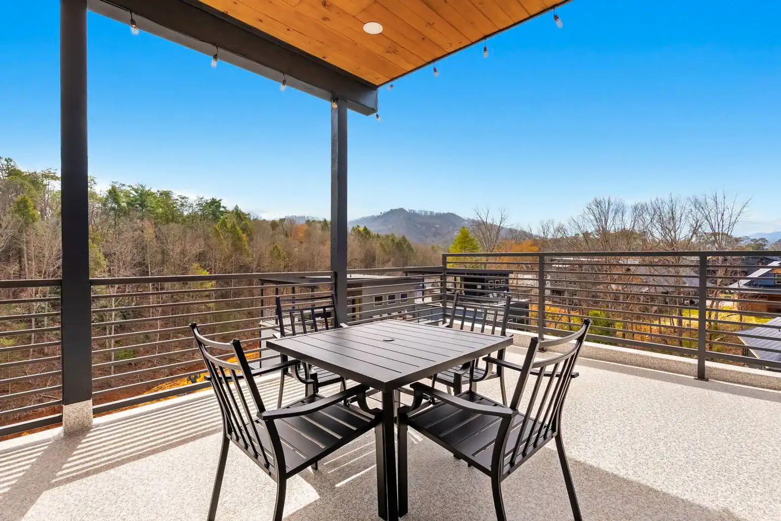 Spacious rooftop deck with mountain views and outdoor dining table