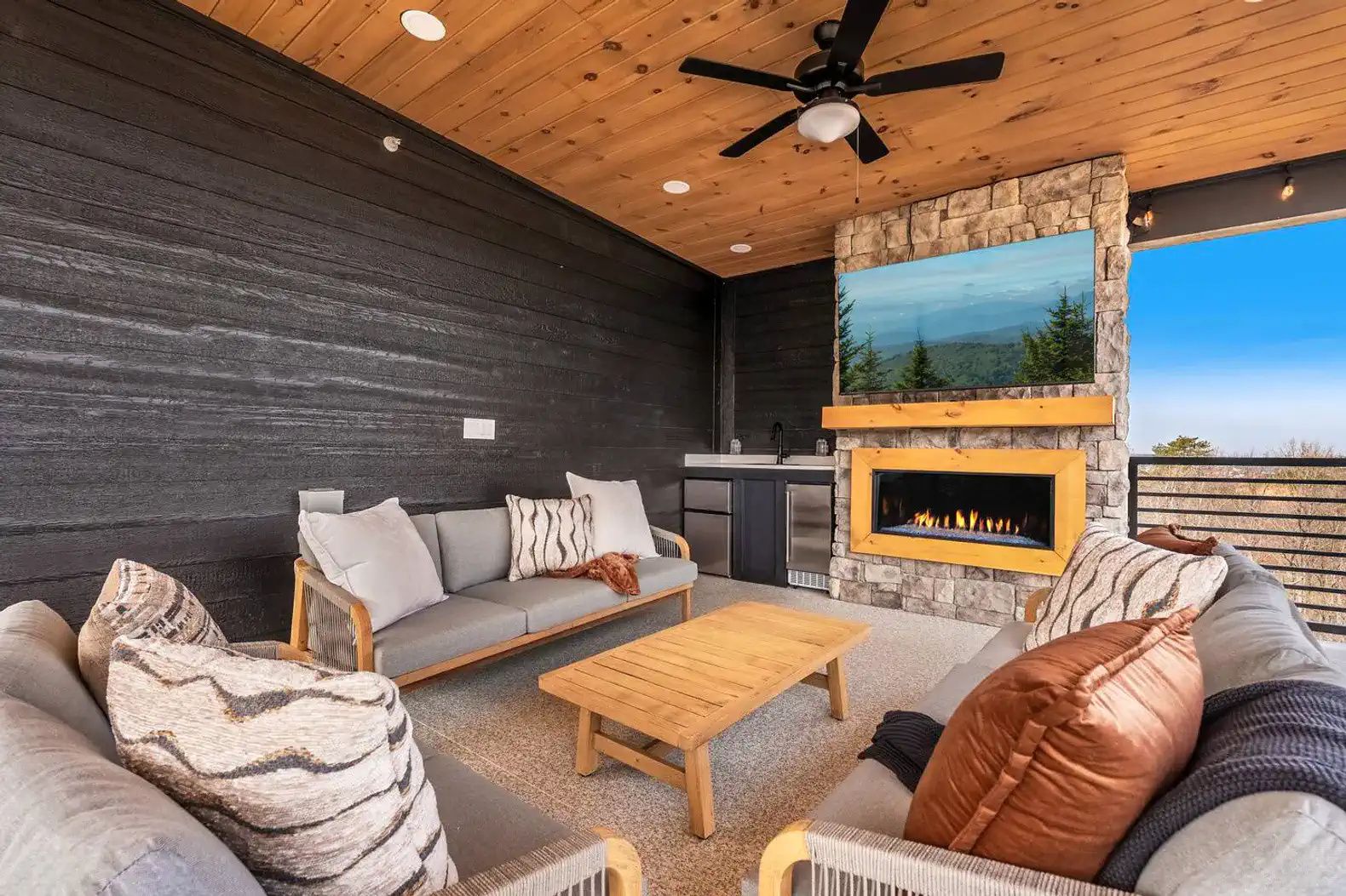 Cozy outdoor seating area with fireplace and mountain views
