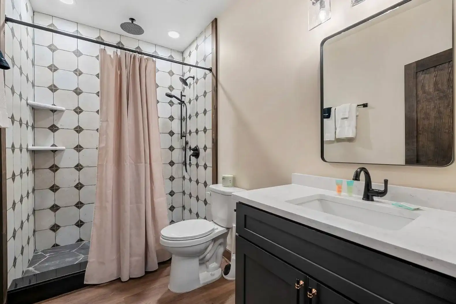 Modern bathroom featuring a walk-in shower with patterned tiles and a stylish vanity