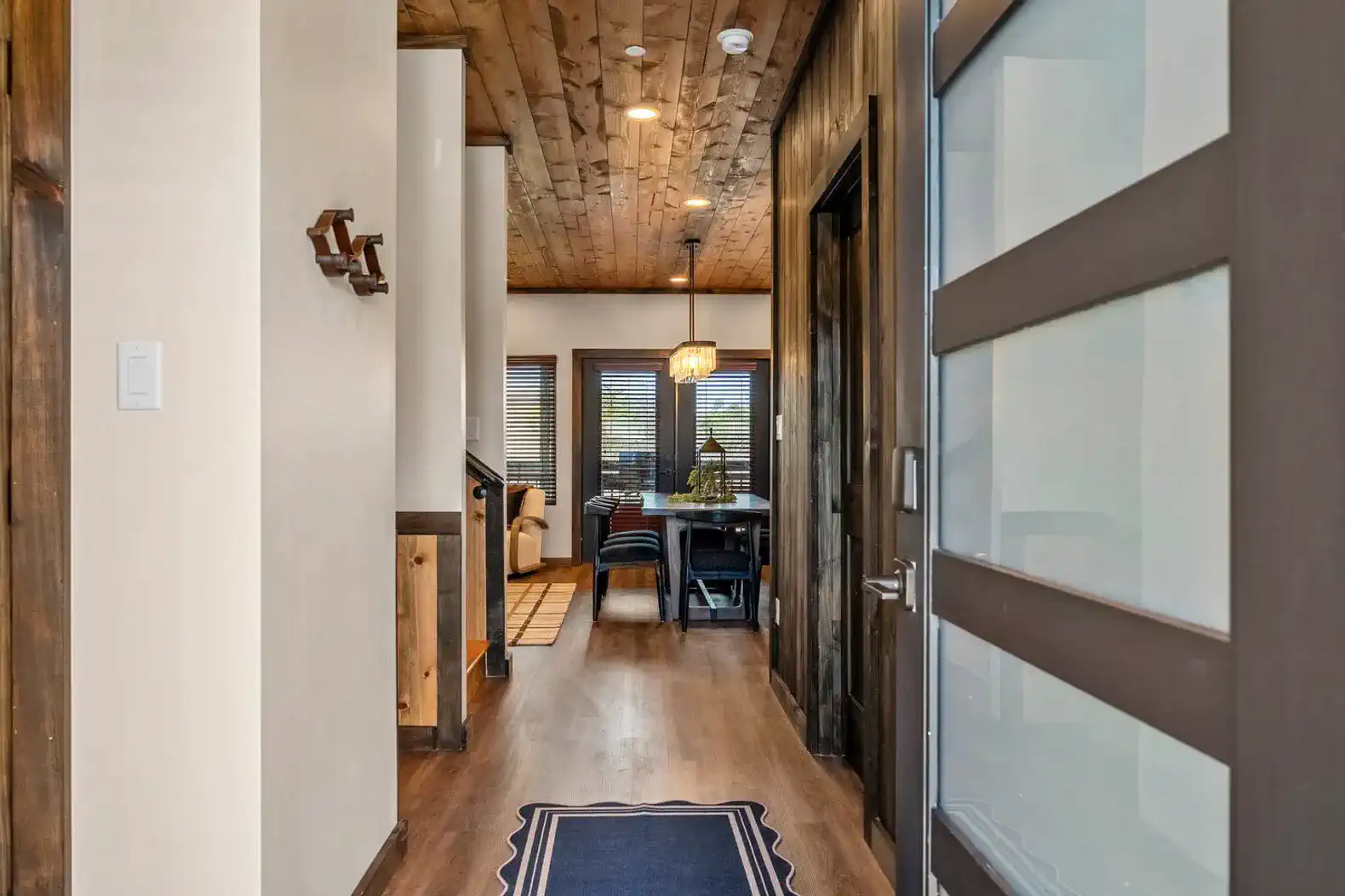 Welcoming hallway leading to a dining area with large windows