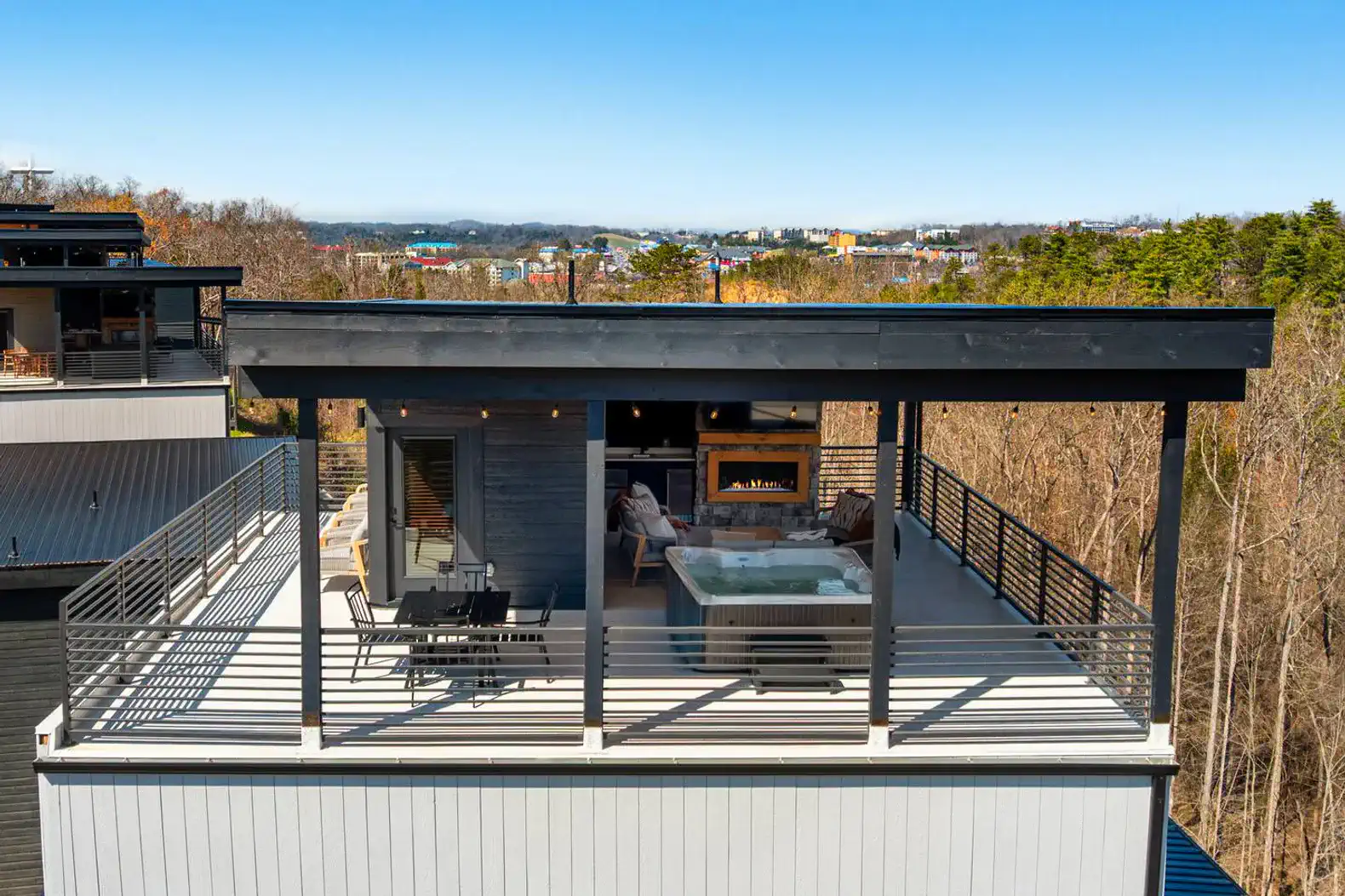 Rooftop deck featuring a hot tub and seating area with scenic views