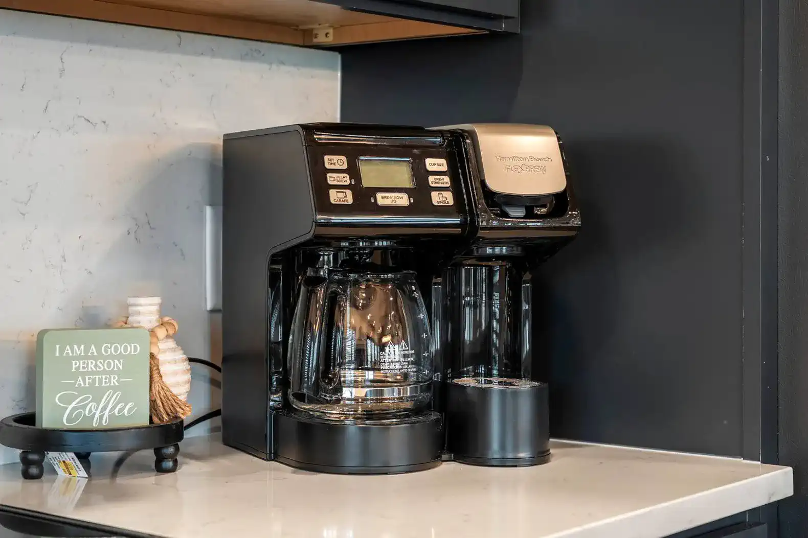 Coffee maker with a glass carafe and single-serve option on a kitchen countertop