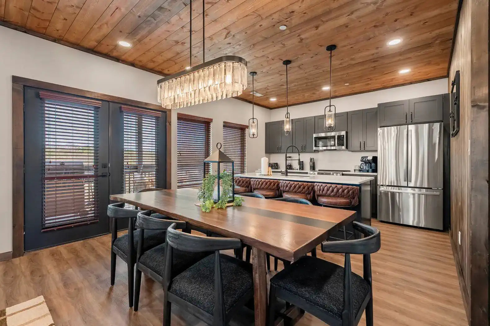 Stylish dining area with wooden table and modern kitchen in the background
