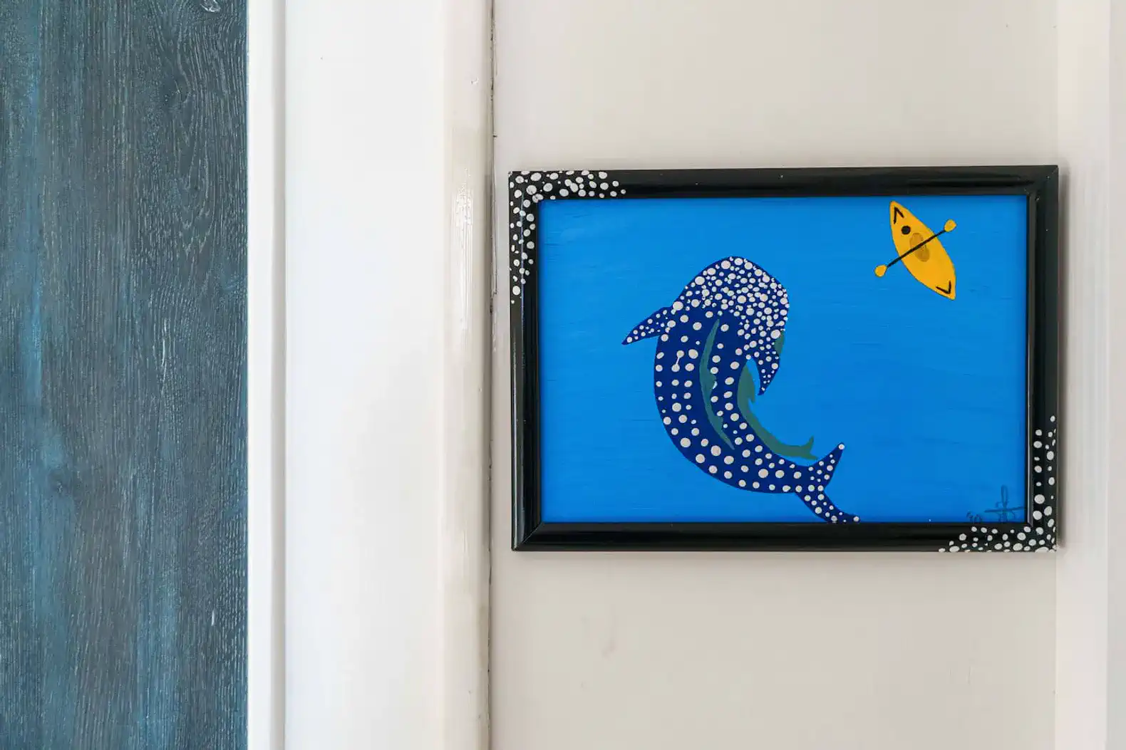 Colorful painting of a dolphin with a kayak on a blue background
