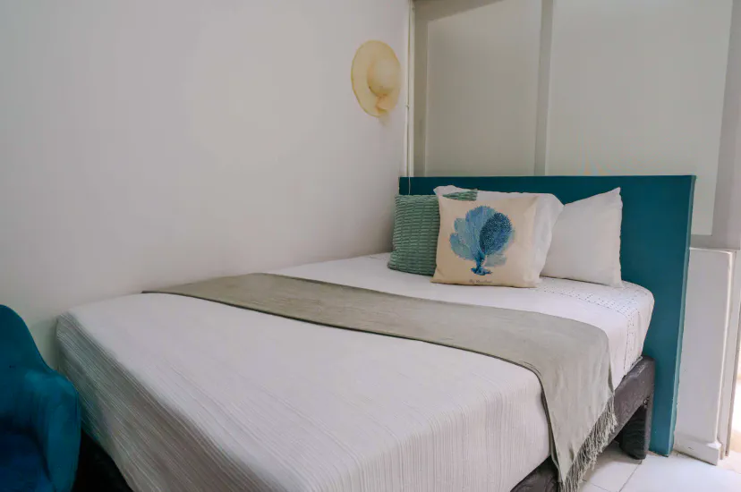 Bright coastal bedroom with crisp linens and a relaxing, minimalist feel