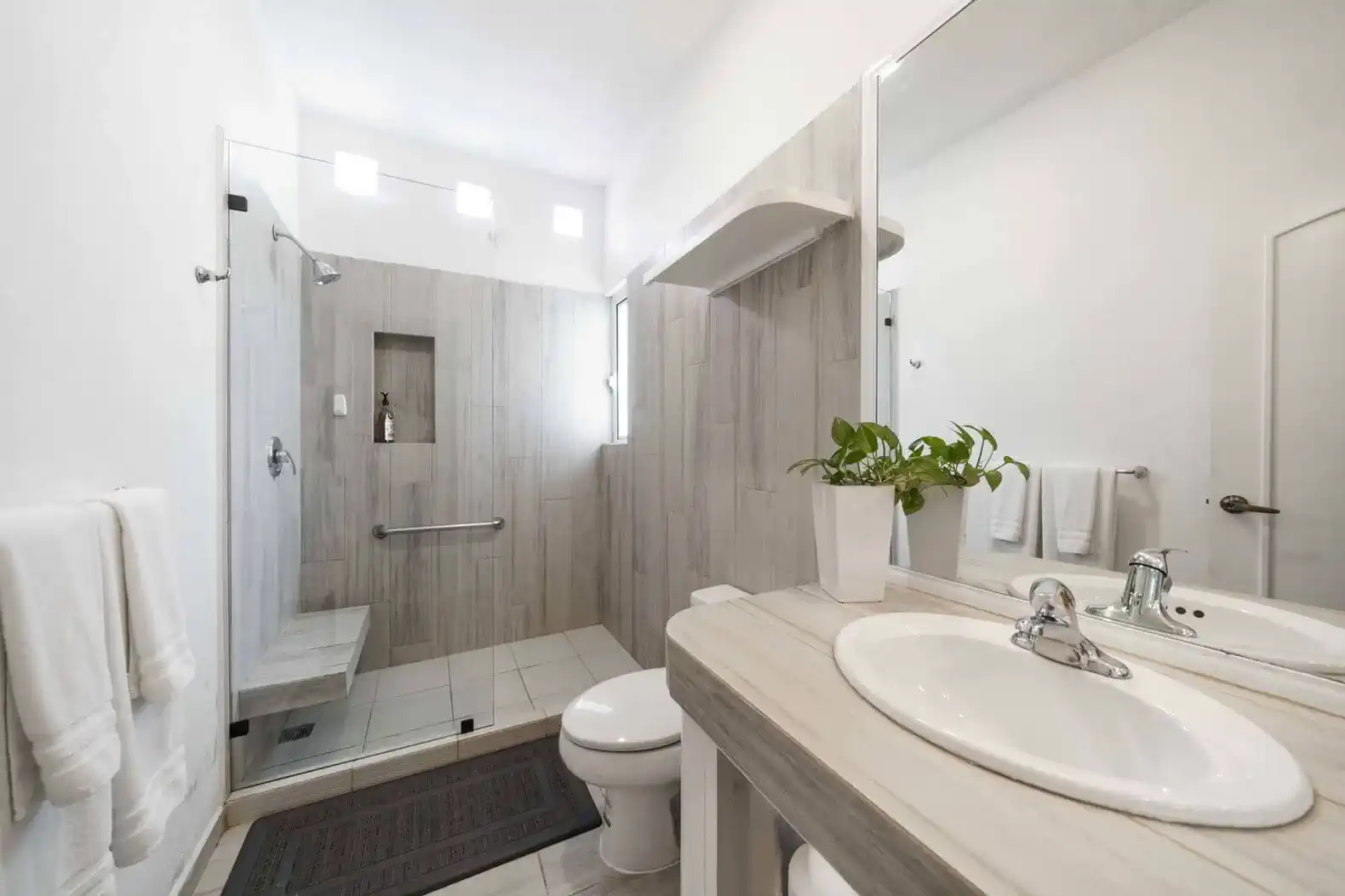 Spacious bathroom featuring a walk-in shower and modern fixtures