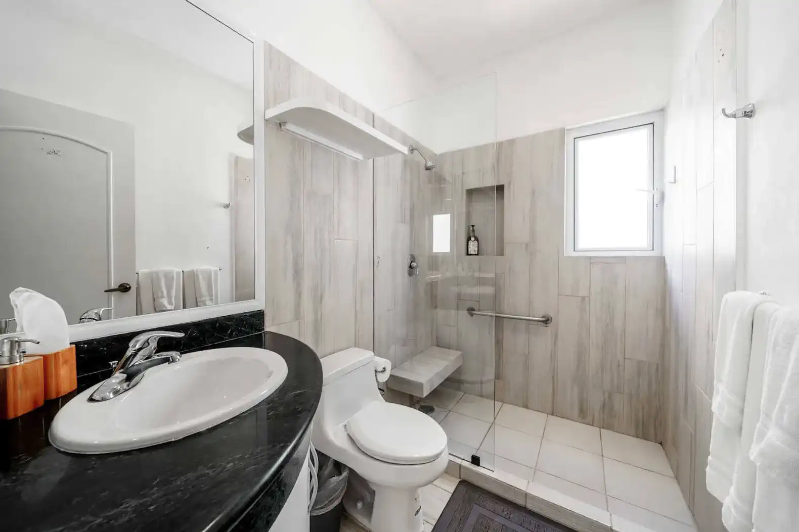 Modern bathroom featuring a walk-in shower and sleek fixtures