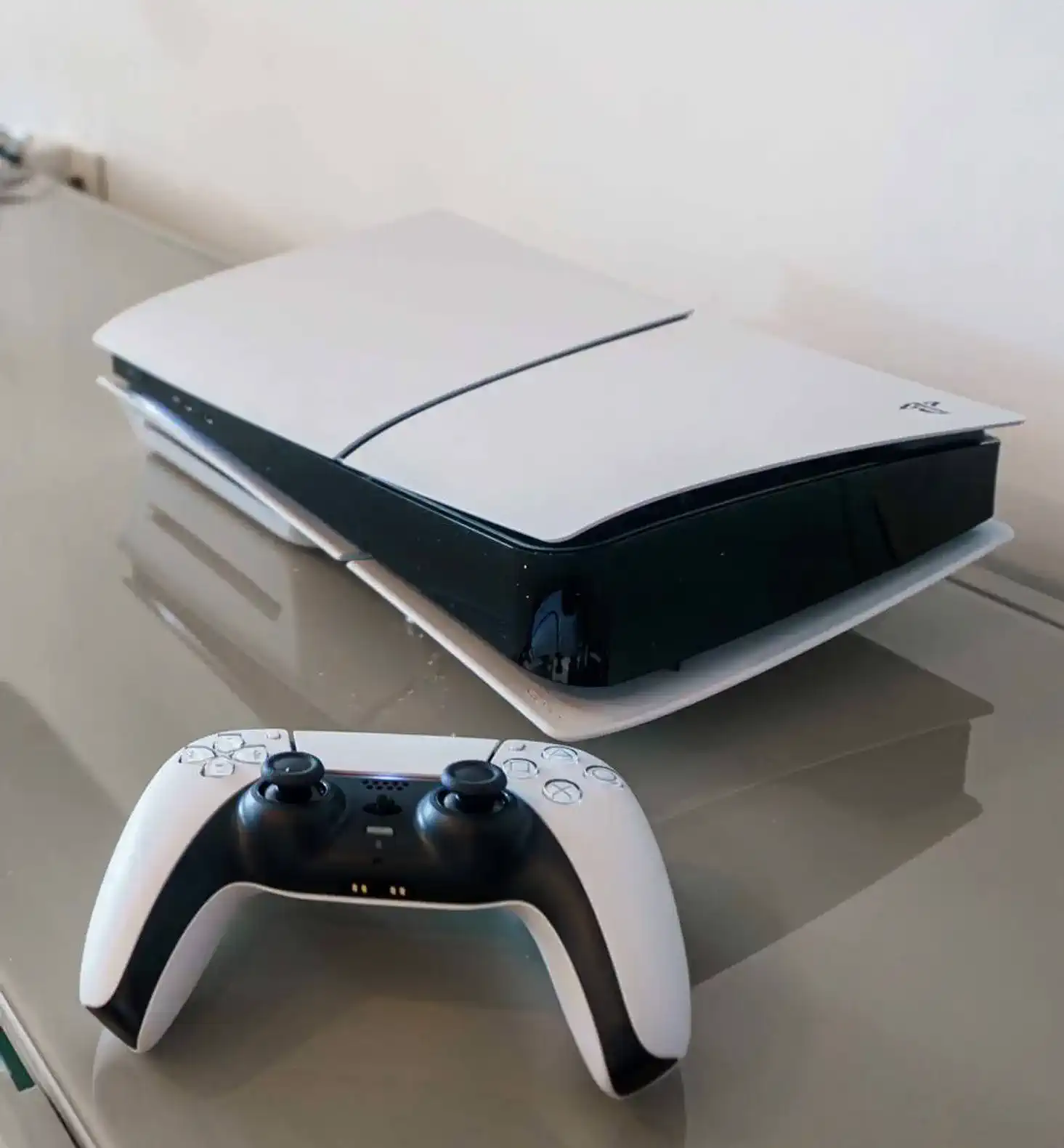 Modern gaming console with controller on a sleek surface
