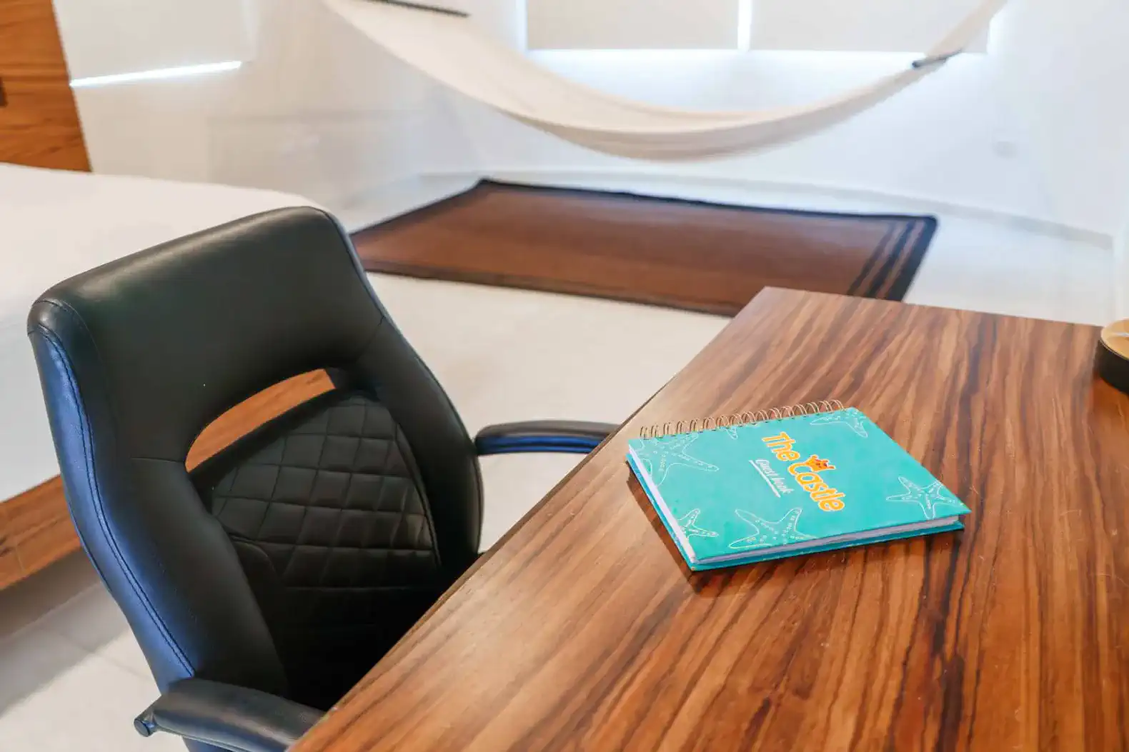 Stylish workspace with a wooden desk and a comfortable black chair