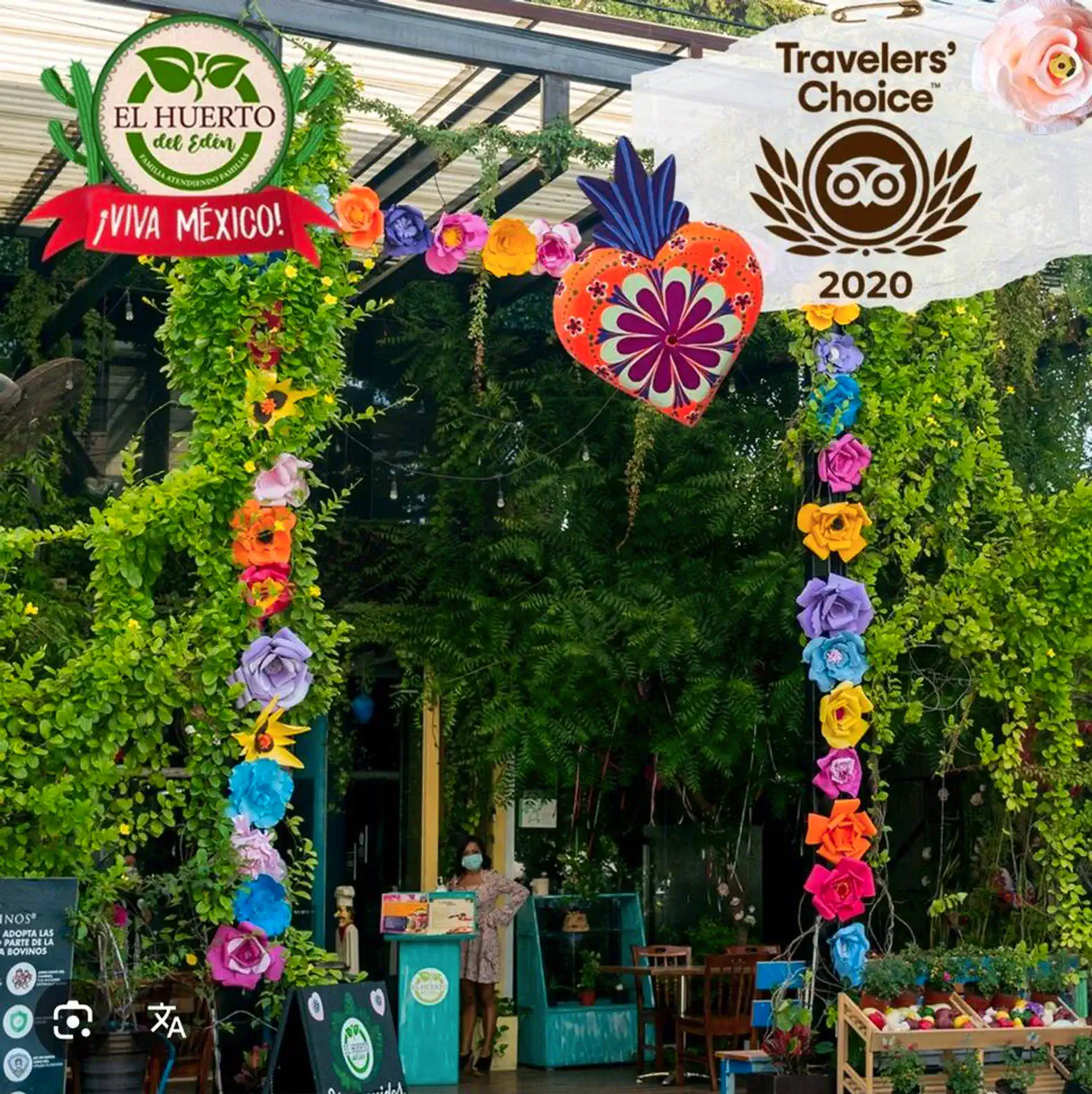 Colorful floral archway adorned with vibrant decorations and greenery