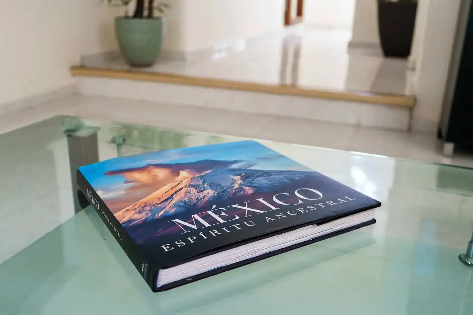 Coffee table book about Mexico with a scenic cover on a glass table