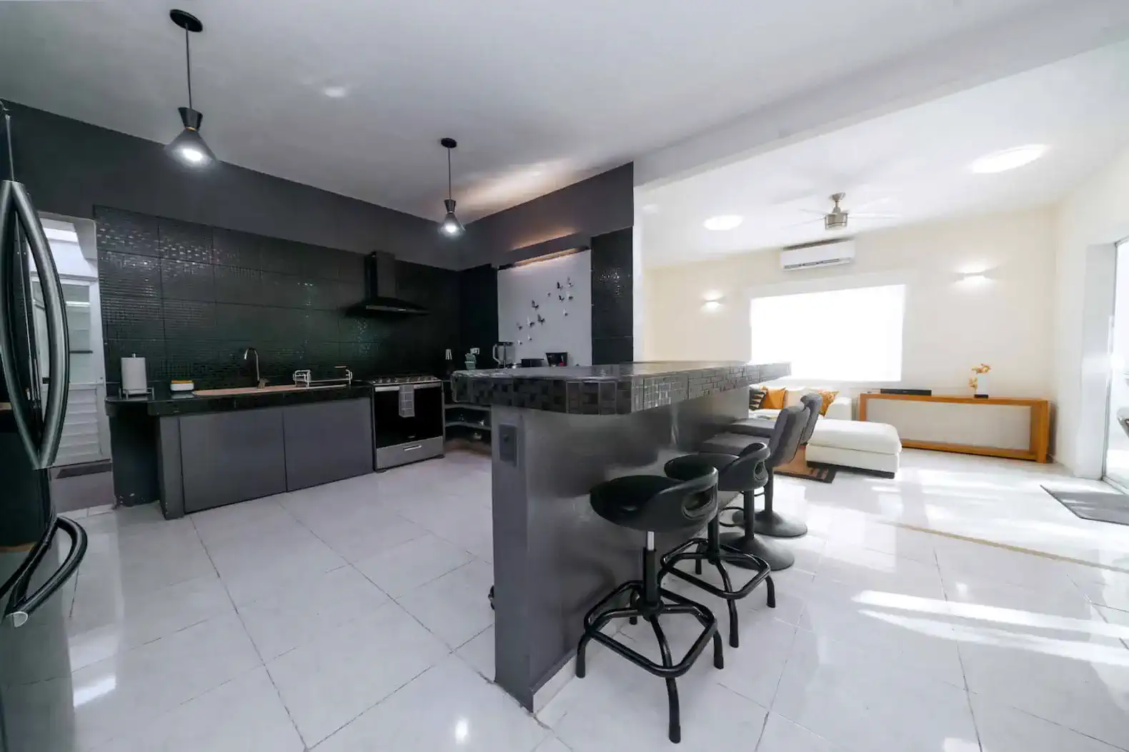 Modern kitchen with sleek black cabinetry and bar seating