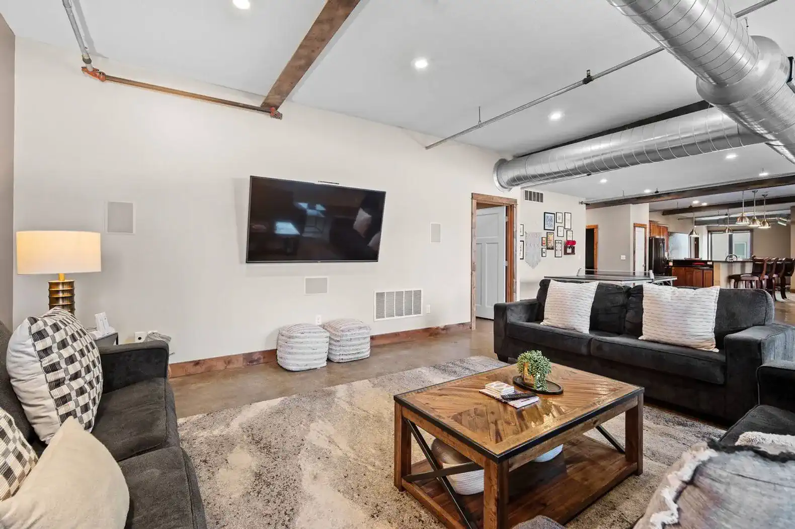 The living room has three sofas, a 75" smart TV, a Nintendo Wii, ping-pong table and so much more!