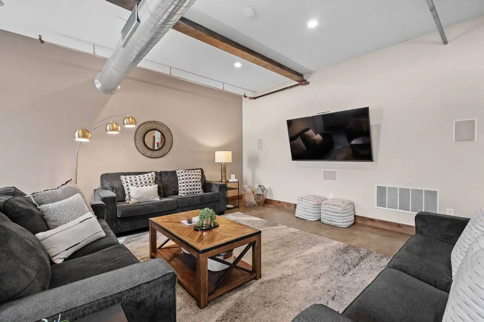 The living room has plenty of seating as well as a 75" smart TV.