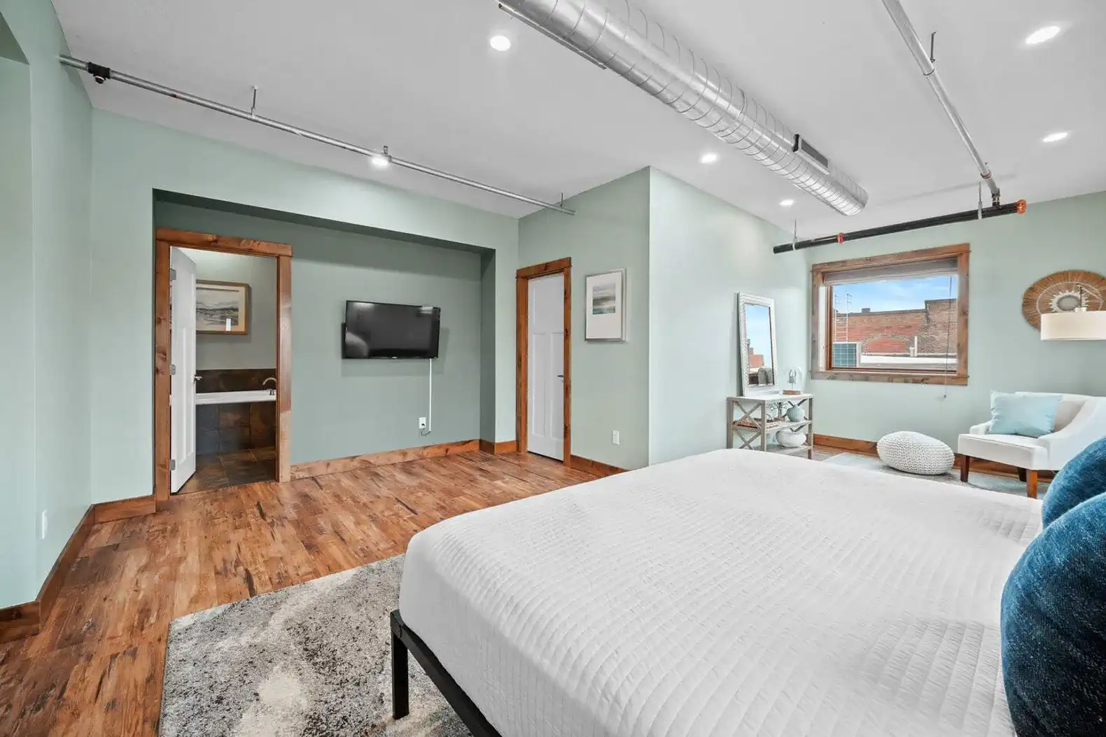Another view of the primary bedroom which also has a 55" smart TV.