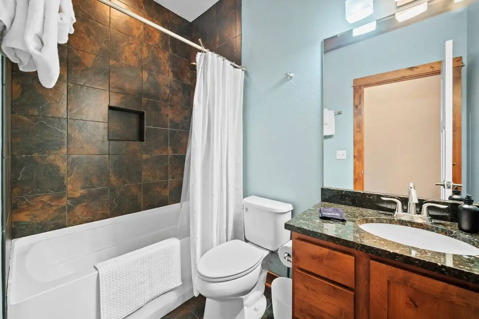 The bathroom conveniently next to the kitchen.