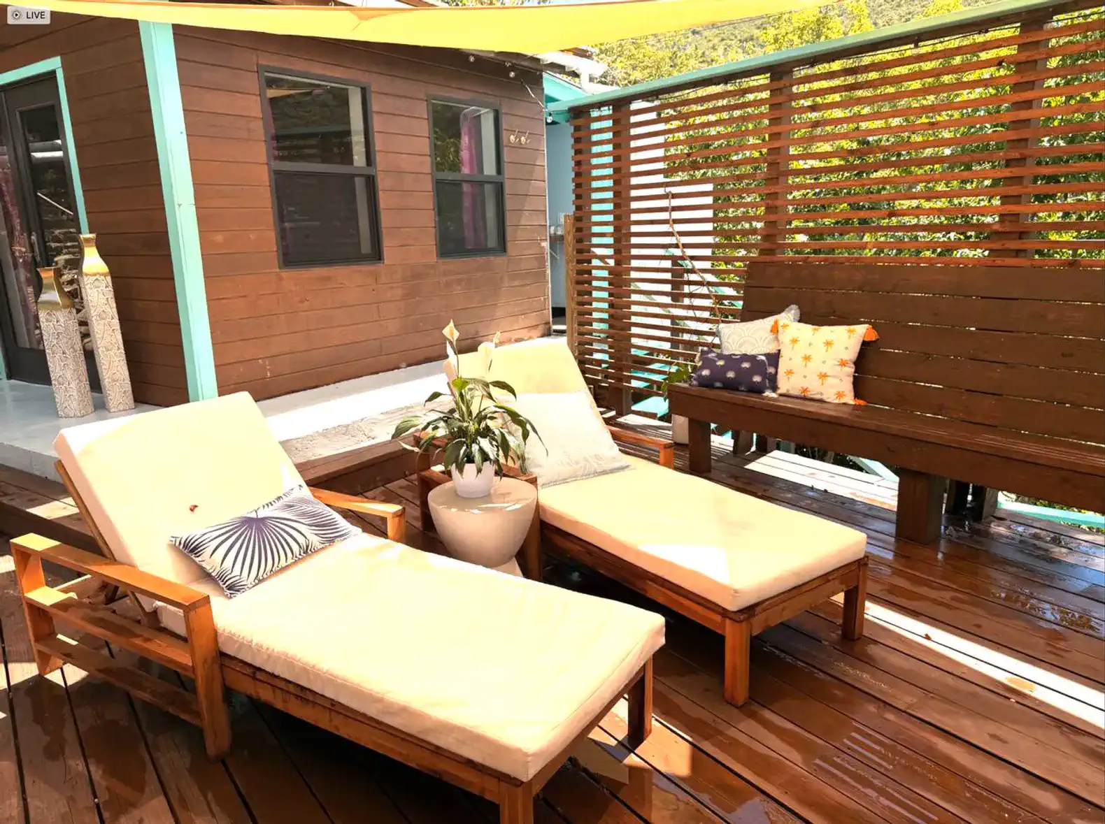 Relaxing outdoor seating area with loungers and decorative pillows