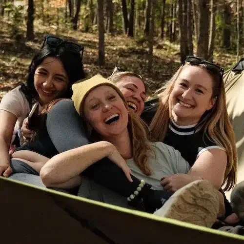 Group of friends enjoying a fun moment outdoors in a forest setting