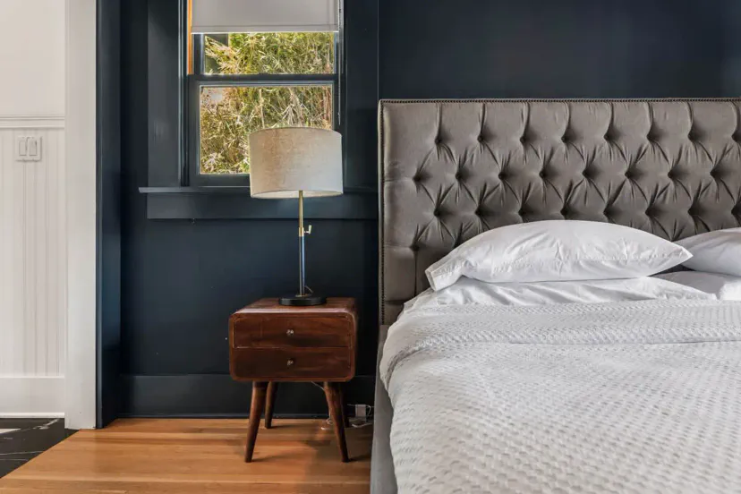 Cozy master bedroom with a tufted headboard and bedside lamp