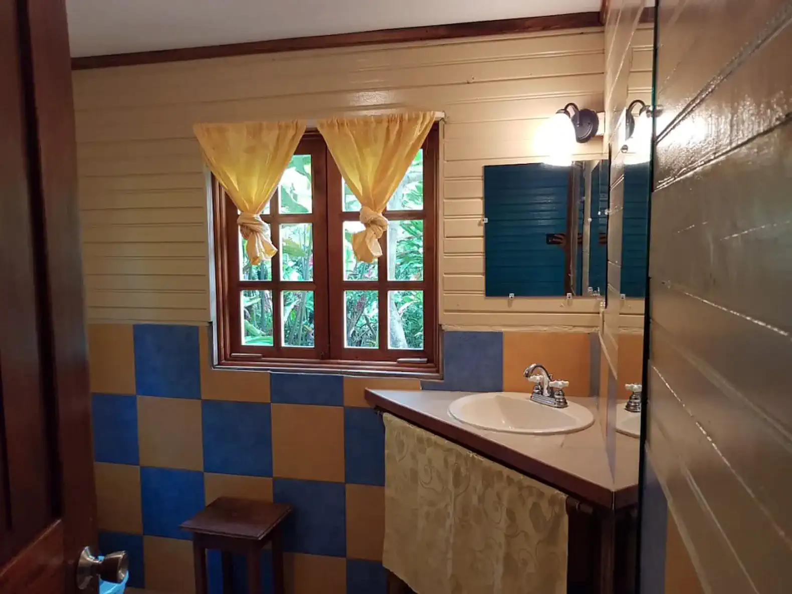 Bright bathroom with colorful tiles and natural light from window