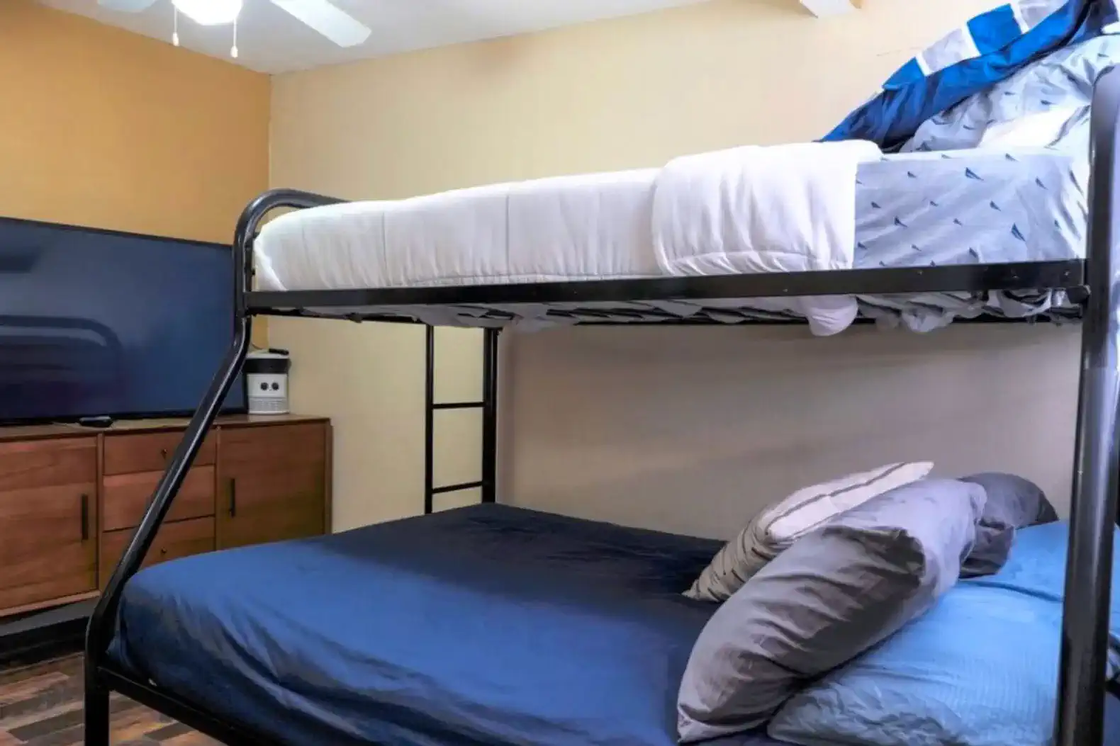 Bunk bed setup with a lower double bed and upper twin bed in a cozy room