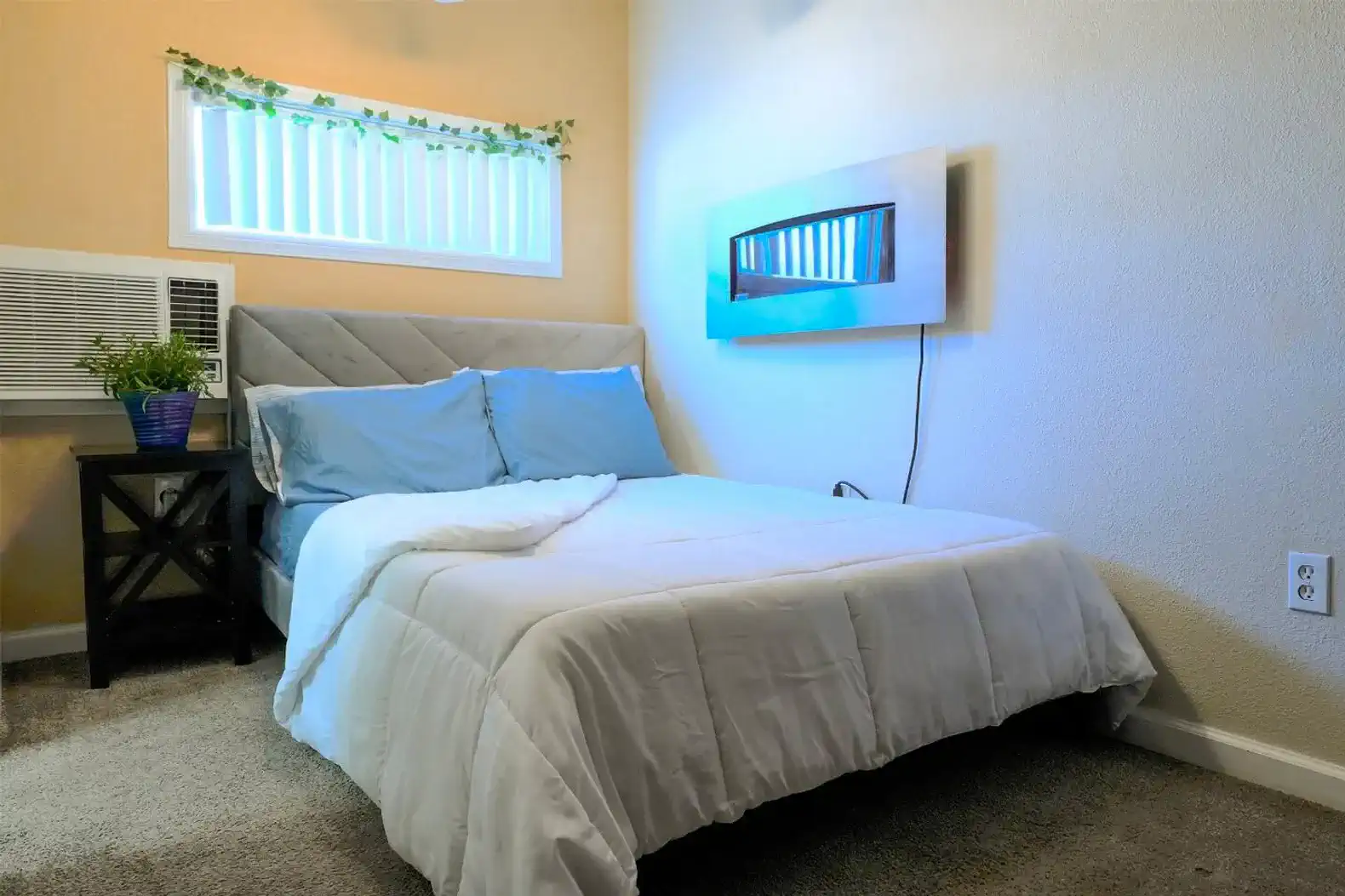 Cozy bedroom with a comfortable bed and air conditioning unit
