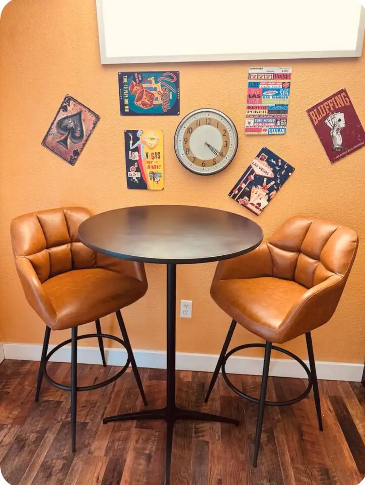 Cozy seating area with two stylish bar stools and decorative wall art