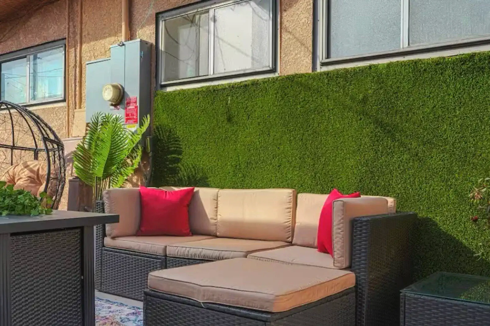 Cozy outdoor seating area with plush cushions and decorative plants