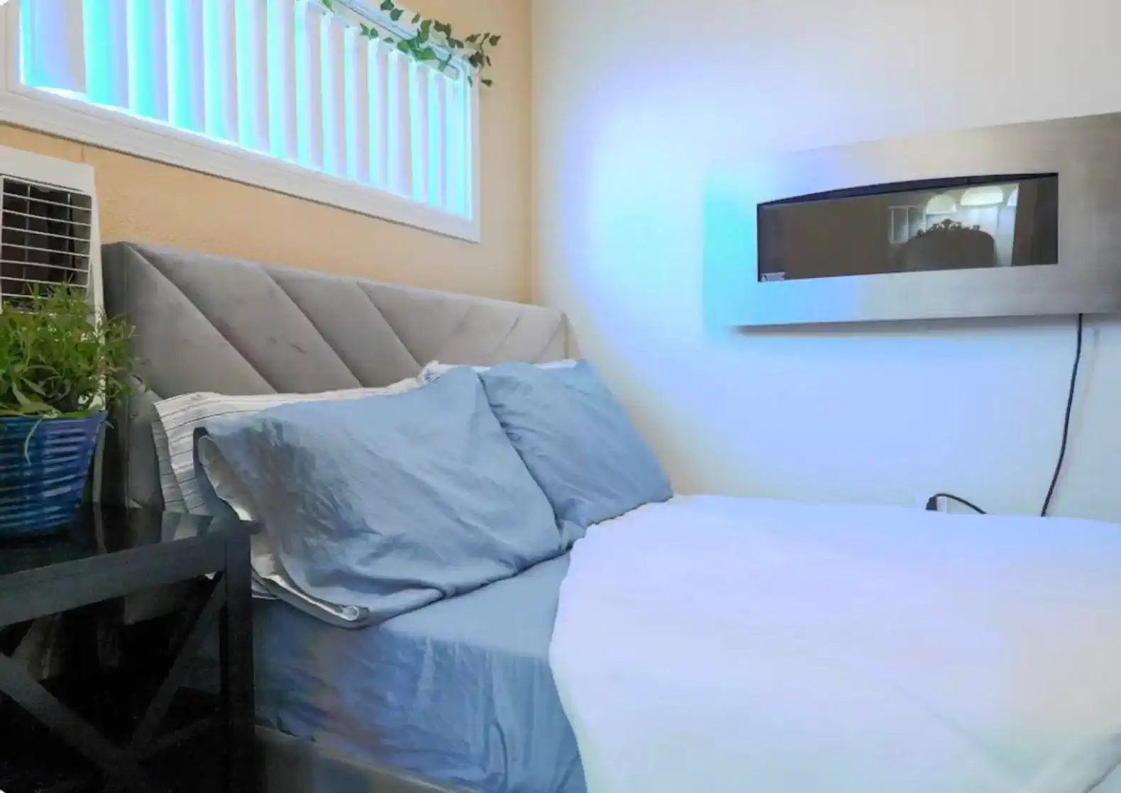 Cozy bedroom with a modern headboard and ambient lighting