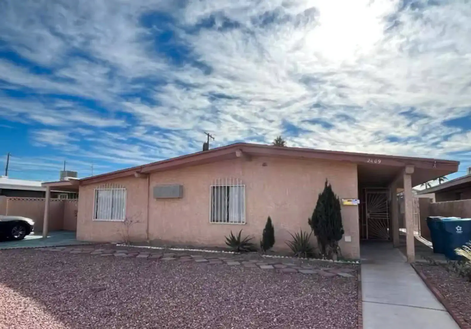 Exterior view of the Fremont Hideaway with a landscaped yard and cloudy sky
