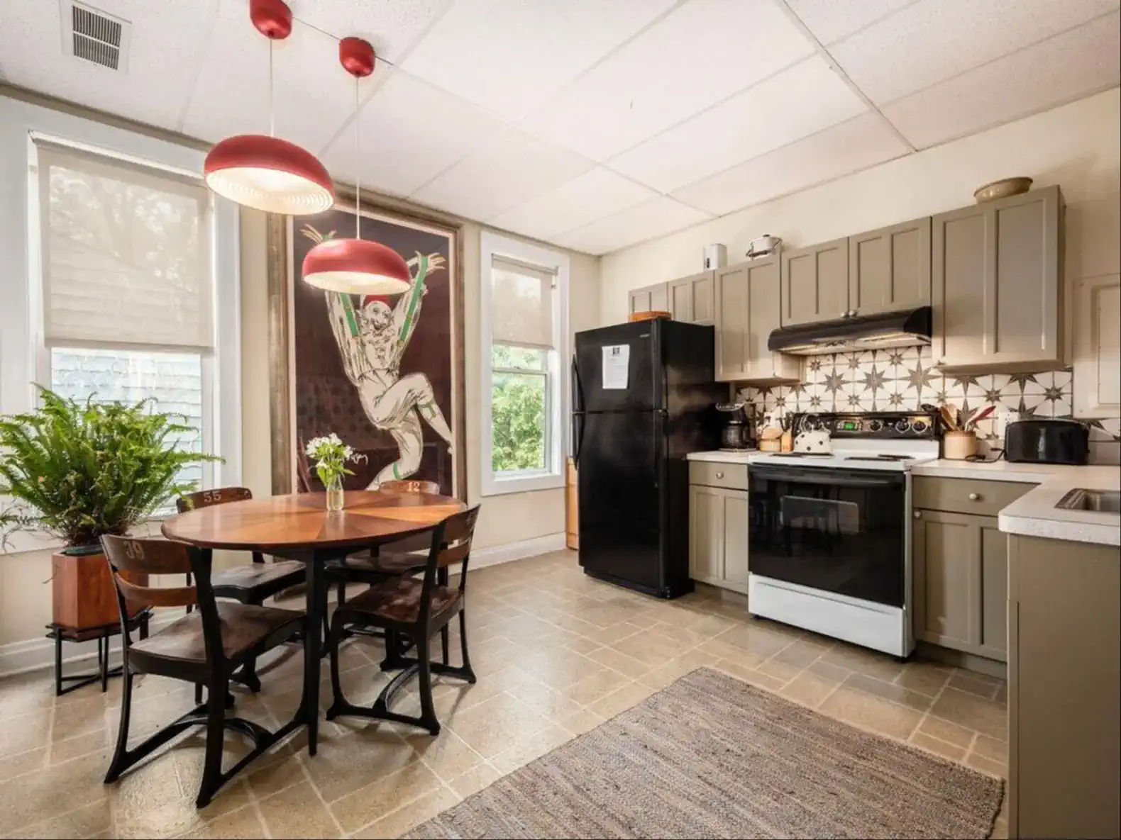 Cozy kitchen with dining table, modern appliances, and artistic wall decor