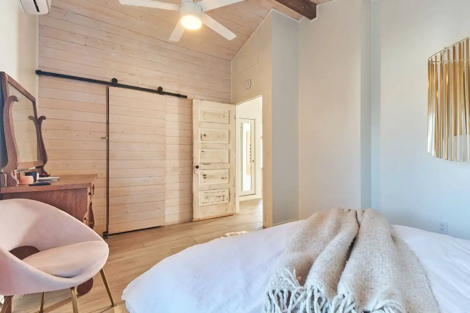 Cozy master bedroom with wooden accents and a sliding barn door